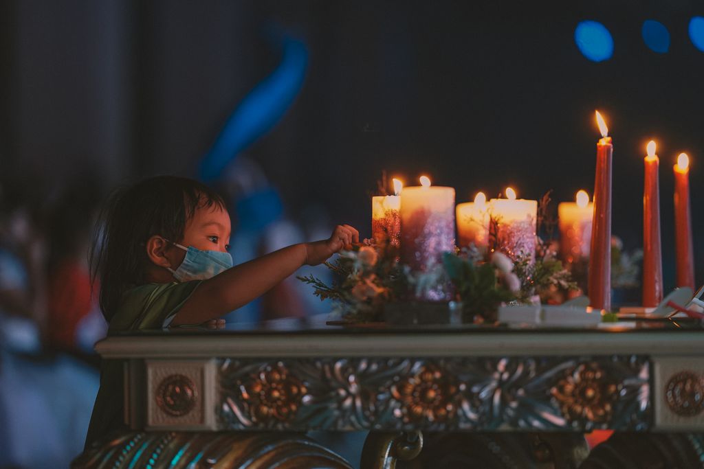 A child lights candles during a traditional ceremony in Jakarta, Indonesia.